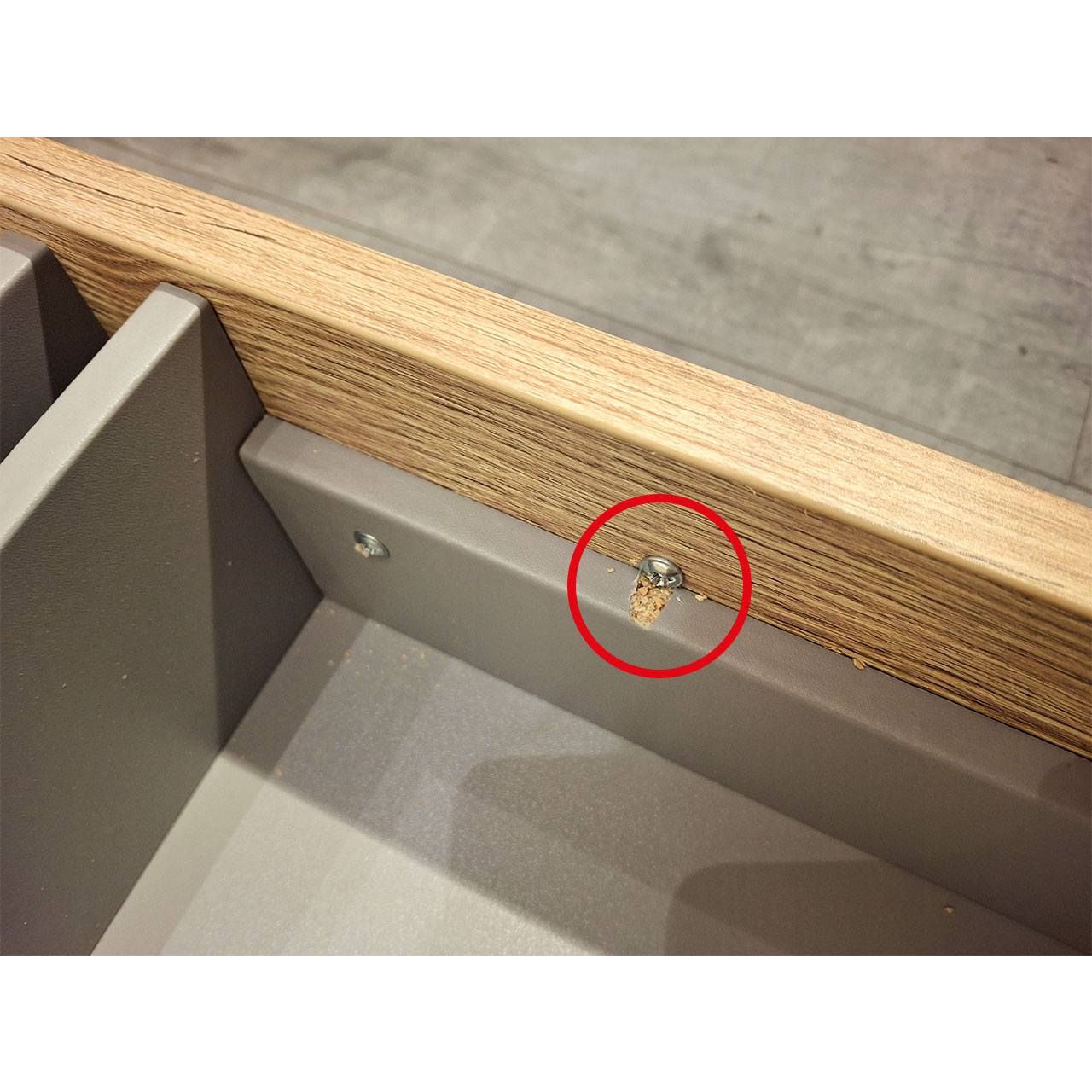 Detailaufnahme einen Schubkastens. Ein Defekt an eeiner Leiste ist mit einem roten Kreis markiert.